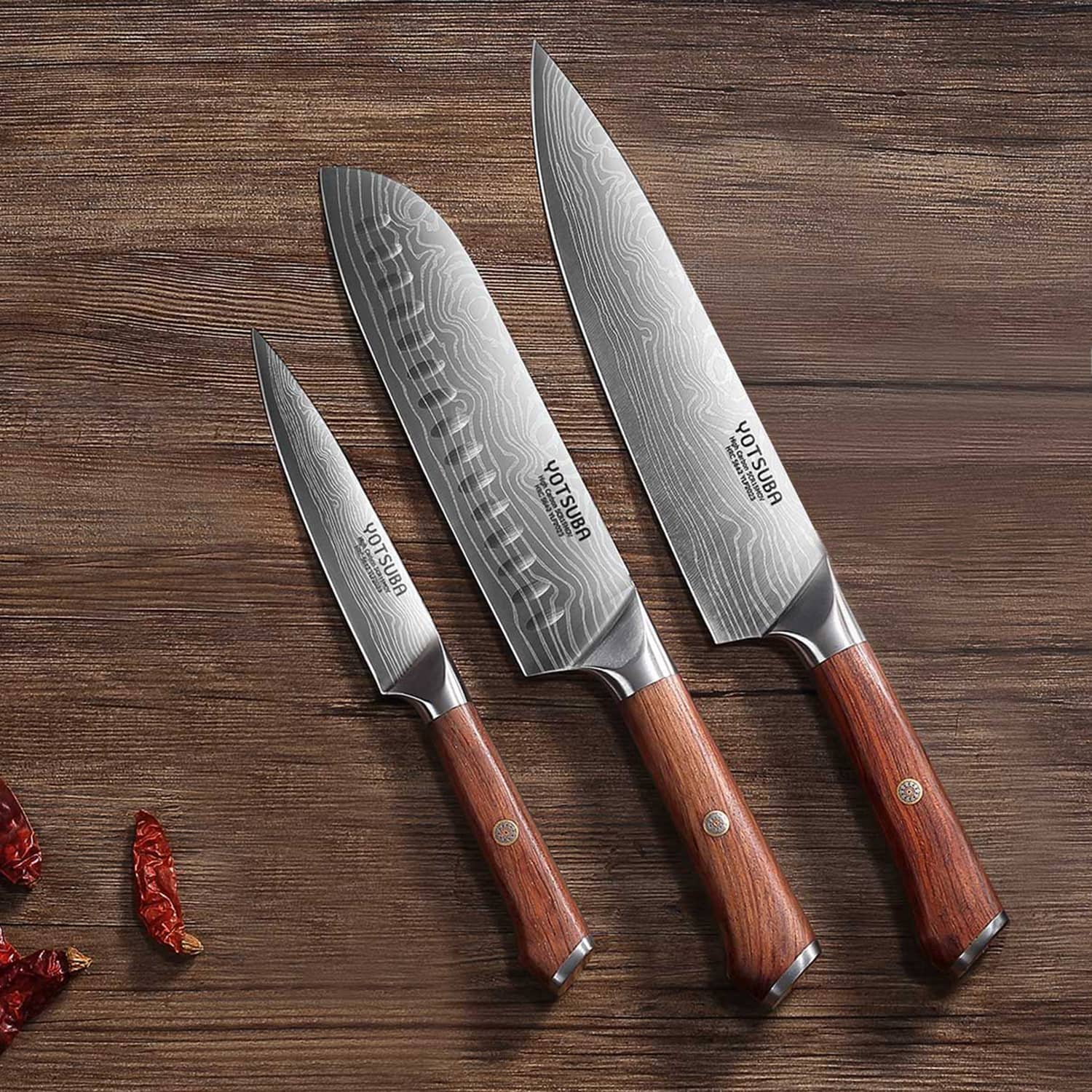Yotsuba chef knife, utility knife, and santoku knife with wooden handles on white backgroundshop_this_look_ggjmrP