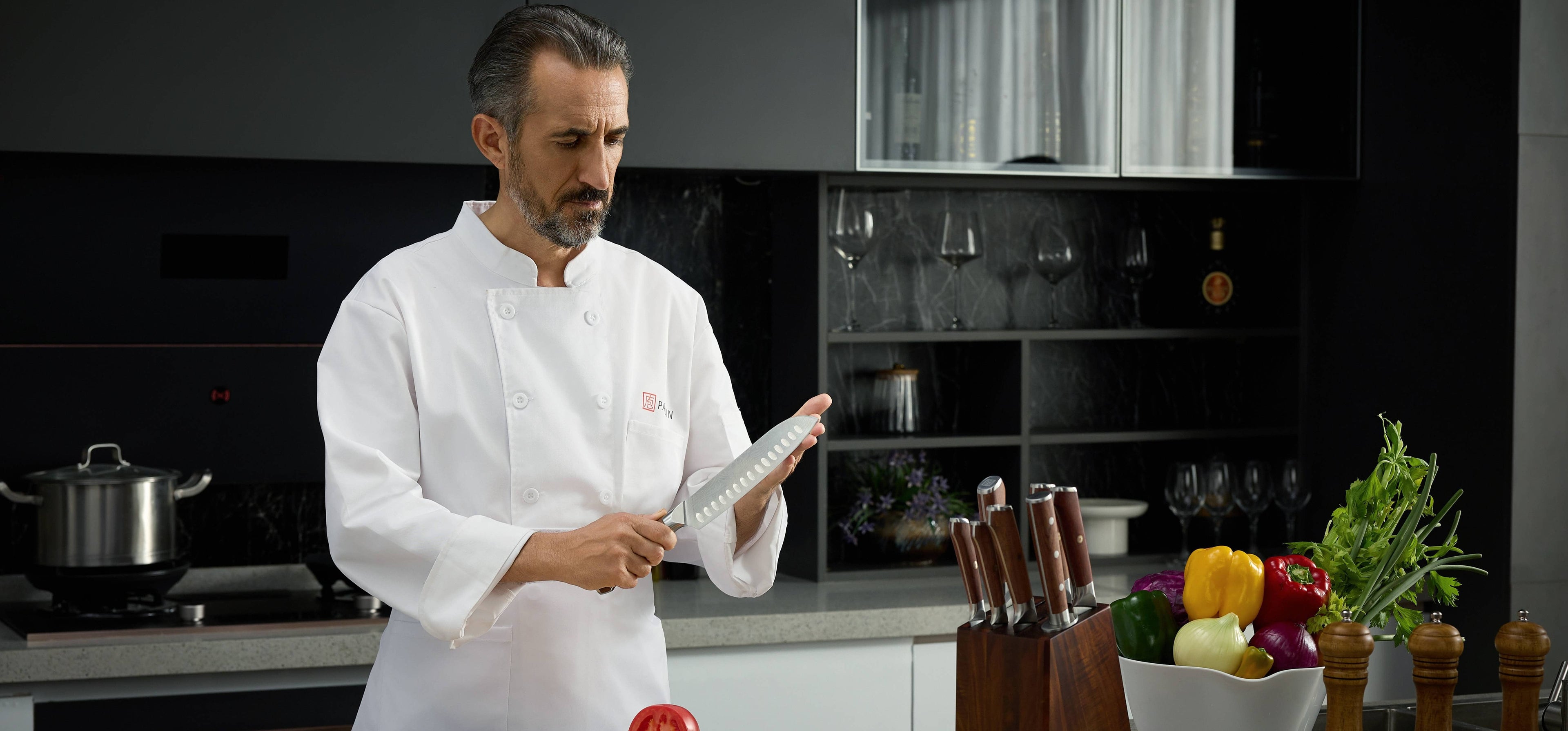 Professional chef sharpening Yotsuba Japanese kitchen knife in modern kitchenslider_item_KT98zp